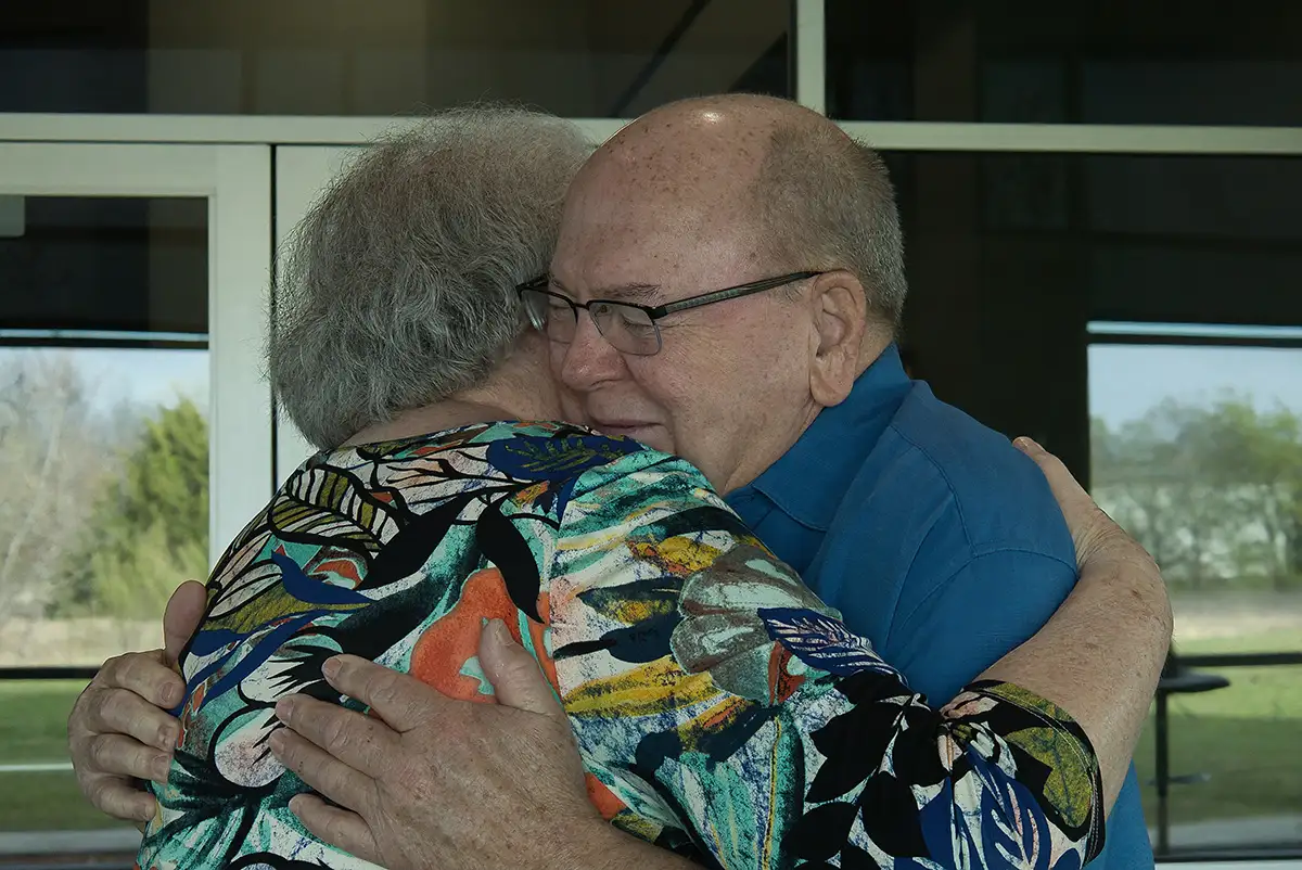 Two members embracing warmly