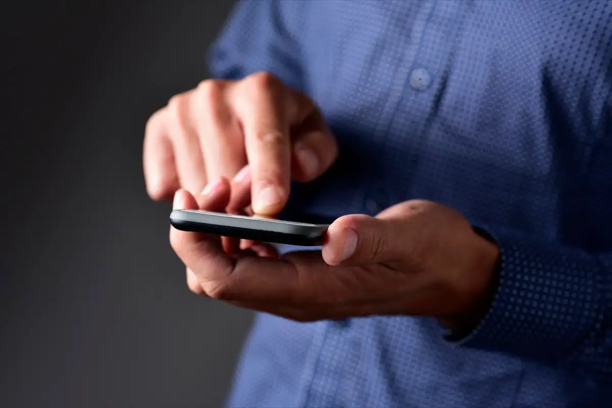 A man reading a text message